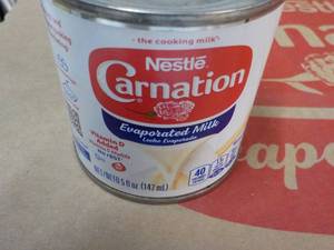 lot 87 image: 24 ct 5 oz Cans Nestles Carnation Evaporated Milk - best date 08312023