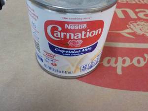 lot 91 image: 24 ct 5 oz Cans Nestles Carnation Evaporated Milk - best date 08312023