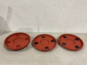 lot 186 image: LOT OF 3 - Round Planter Caddies with Wheels - Red