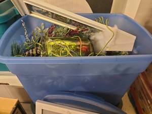 Blue tote of holiday decor and decoration items