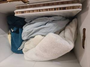 Tote of Clean linens and scrapbooking books