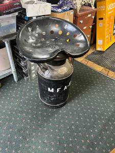 lot 9 image: Cream Can with Tractor Seat