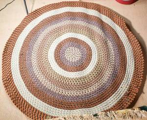 lot 64 image: Large Circular Warm Toned Woven Rag Rug