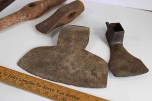 lot 6 image: Axe and hammer lot. Splitting maul head, adze pick head, railroad spike hammer head, and broad axe with 11 blade
