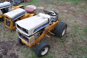 lot 19 image: Cub Cadet parts tractors, 1450 and 125, missing engines, with box of misc. Cub Cadet parts