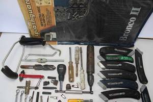 lot 53 image: Assorted Box Cutters, Nut Drivers, New Splash Guards for a Ford Bronco II, Wrist Rocket, and More