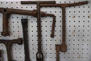 lot 128 image: Board of 9 antique T wrenches