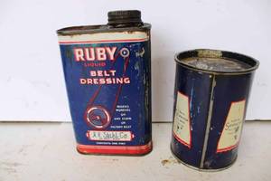 lot 131 image: Pair of Stahl Co. cans, one is a Ruby belt dressing 6 tall, the other is a Trophy 1 lb. grease 4 tall, both are metal cans