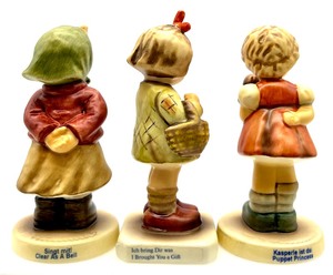 lot 129 image: GOEBEL M.I. HUMMEL Clear As A Bell, I Brought You A Gift, Puppet Princess Club GOEBEL M.I. HUMMEL