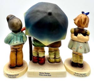 lot 131 image: GOEBEL M.I. HUMMEL Lucky Fellow, Stormy Weather, Two Hands, One Treat Club Figurines