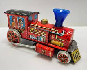 lot 134 image: Vintage Modern Toys Battery Operated Bump-N-Go Tin Litho Toy Train