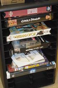lot 19 image: Spinning Shelf with Collection of Vintage VHS Tapes, DVDs, CDs