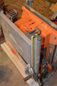 lot 7 image: Rigid Work-N-Haul-It Two Wheeled Working Stand Table Saw