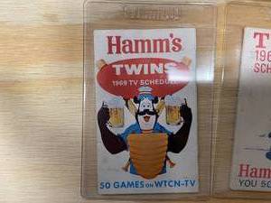 lot 113 image: Hamms Heavy Hitter Framed Sticker and Twins 1965 and 1969 TV Schedules