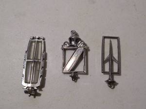 lot 124 image: (3) Vintage Hood Ornaments