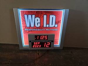 lot 11 image: We I.D. Bar Sign