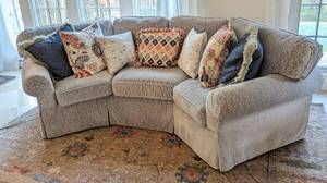 lot 4 image: Stunning Silver Chenille Crescent Sofa and Colorful Pillows