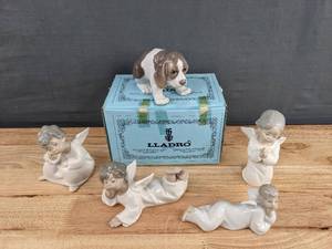 lot 121 image: Lladro Set of Four Angel Figurines and a Dog Figurine   K