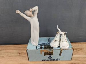 lot 106 image: Lladro Porcelain Figurine and a Pair of Baby Shoes K