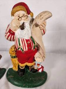 Two Hand Painted Cast Iron Santas with their Lists
