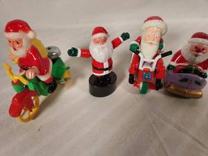 Four Vintage Wind Up Santa Toys