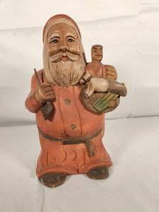 Carved Santa Holding Pipe and Toys