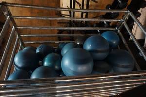 lot 554 image: Large Lot of Yoga Fitness Balls With Wheeled Storage Container