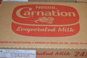 lot 242 image: Case of Nestle Carnation Evaporated Milk 24 5oz Cans Best By 08312023