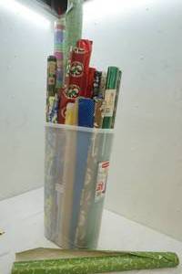 lot 26 image: Variety of wrapping paper in plastic carrier