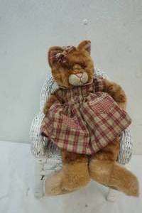 lot 79 image: Stuffed Cat sitting in a Wicker chair