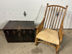 Wood rocking chair with cushion seat and old metal covered trunk.