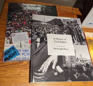 Assorted Coffee Table Books and Decorative Wicker Holder