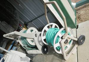 lot 72 image: Two garden hose reels with hose