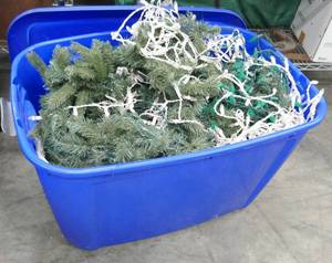 lot 138 image: Tote full of lighted christmas greenery and 2 strings of lights