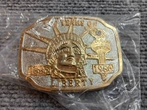 lot 41 image: 1986 Liberty Belt Buckle Diamond Chip