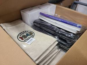 Box full of birthday year themed decor and items