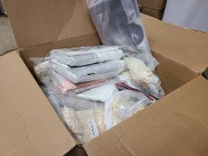 Box of new doilies, flags, and other linens