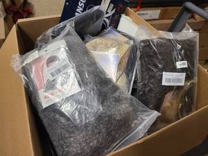 Box of various styles of costume wigs