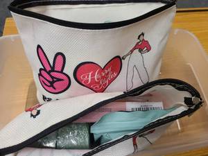Tray of beauty items and Harry Styles bags