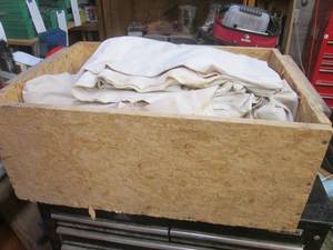 lot 7 image: Large wood box full of throw tarps