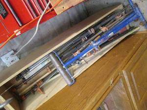 lot 261 image: Tall wood box full of assorted bar clamps