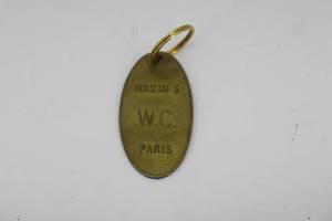 lot 23 image: Maximis Paris W.C. Brass Keychain