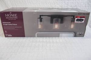 lot 63 image: Home Decorators Collection Helenwood 22 in. 3-Light Matte Black Bathroom Vanity Light with Clear Seeded Glass
