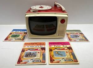 lot 43 image: 1960s General Electric Shown Tell Record PlayerViewer And Some Records