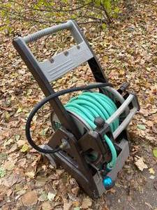 lot 300 image: Ames Rolling Hose Reel with Garden Hose and Sprayer