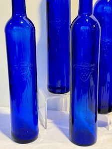 lot 259 image: Five Decorative Cobalt Blue Tall Glass Bottles