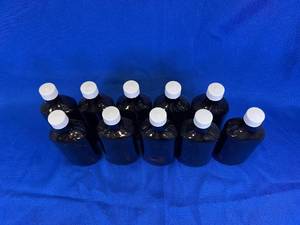 lot 31 image: 10 - Amber Glass Oval Bottles, Graduated 8 oz.