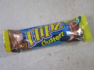 lot 182 image: (B-1) Box of 24 Flipz Clusterz Candy Bars Past Date