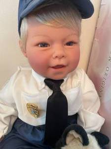 lot 106 image: Lee Middleton Doll - Police Officer