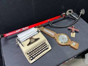 lot 1435 image: Type Writer, Boyds Airplane, Pogo Stick, and Barometer